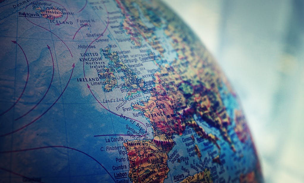 Detailed close-up of a globe showing parts of Europe and the Atlantic Ocean.